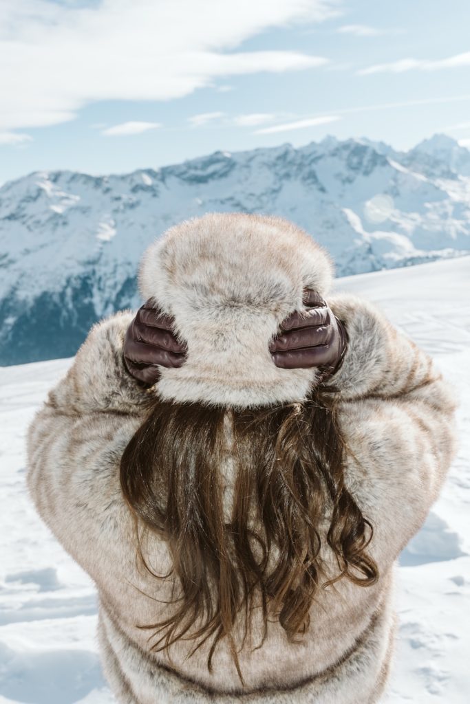 Fashion-inspired winter portrait in St. Moritz with snow-covered Swiss Alps