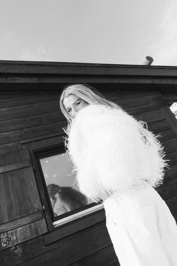 Black and white fashion portrait in St. Moritz near an alpine hut