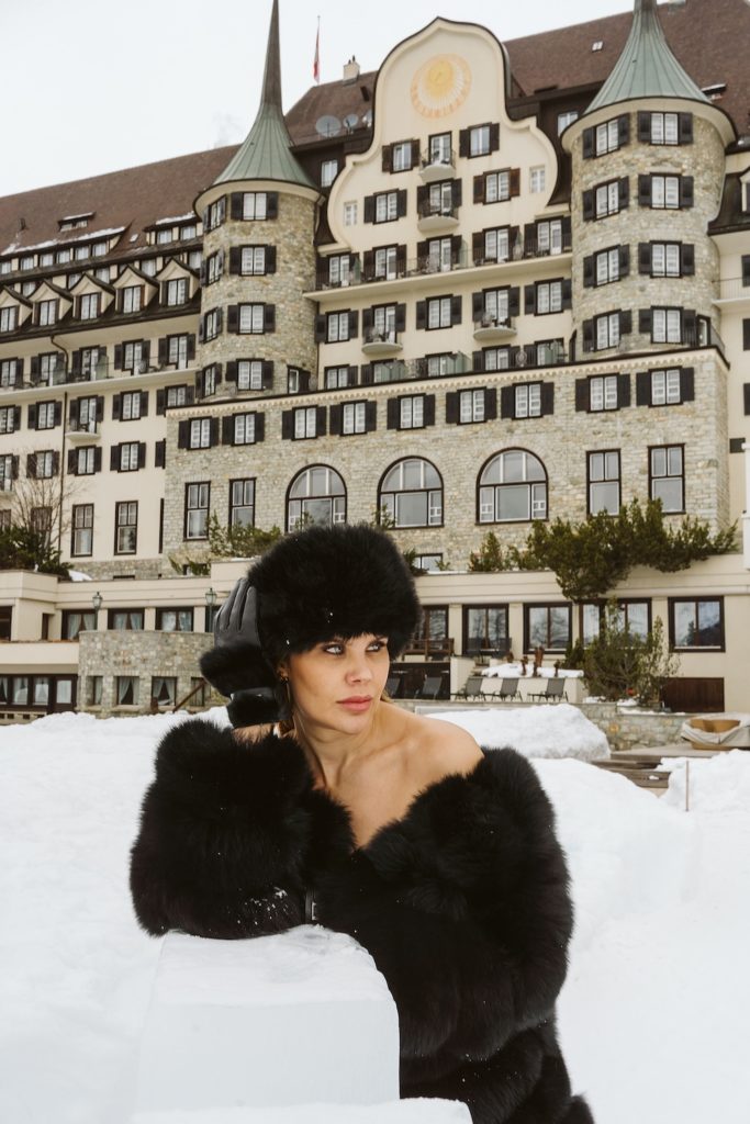 Fashion portrait in front of classic St. Moritz hotel architecture